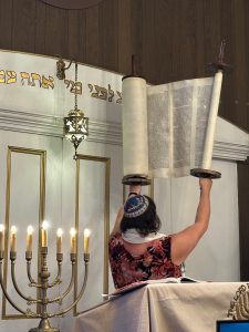 Rabbi Aria Caligiuri holds the 200-year old torah high as we welcome the Jewish new year.